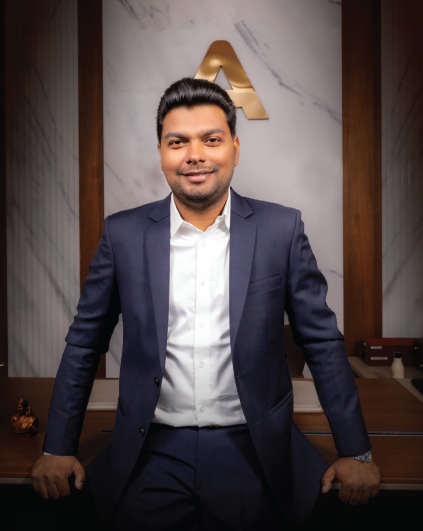 Mr. M. V. Manikandan, the real estate agency's founder and managing director, in business attire.